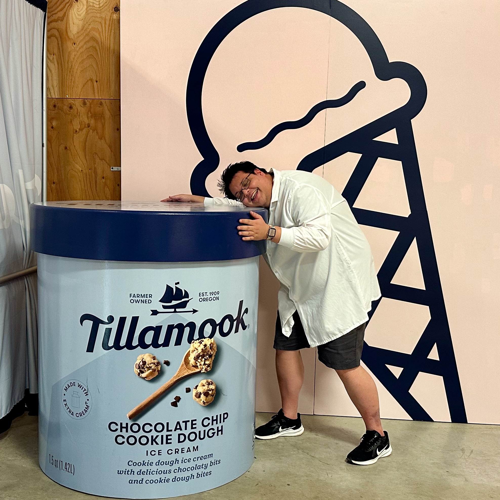 Michael in a lab coat hugging a giant ice cream container Michael in a lab coat hugging a giant ice cream container
